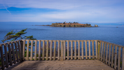 A beautiful view of small island. A wooden fence on the beach. Cape flattery trail , Olympic Peninsula, Washington state