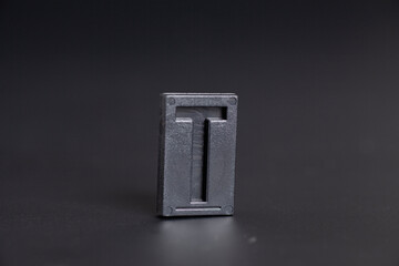 Letter Press T on black background