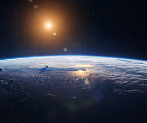 Surface of planet Earth in space. Orbit of planet. Sunrise on Earth. Sky, clouds and ocean. Sun and...