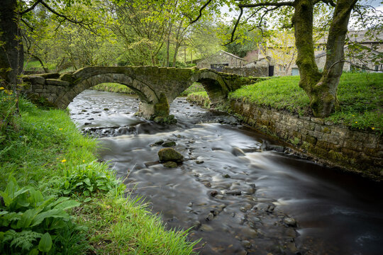 A long exposure photograph of the ancient pack horse bridge at Wycoller, Lancashire