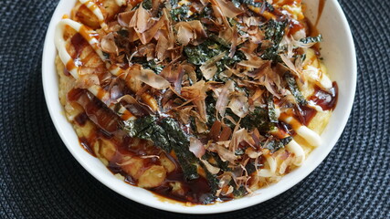 Japanese-style pancake with dried fish flakes and seaweed toppings