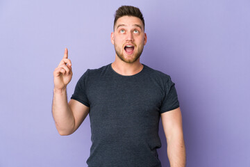 Fototapeta premium Russian handsome man over isolated background pointing up and surprised