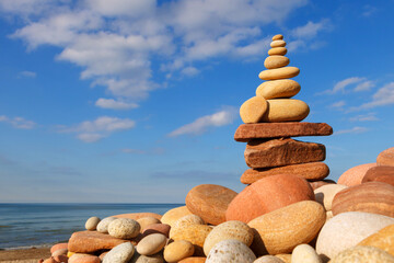 Rock zen pyramid of colorful pebbles on the background of the sea. Concept of Life balance