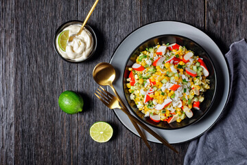 Crab salad on a dark wooden background, top view