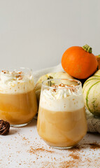 Coffee latte from pumpkin. Warm spicy drink in a glass glass close-up, selective focus