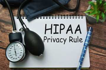 Selective focus of pen, sphygmomanometer, inscription with notebook written with HIPAA ( Health...