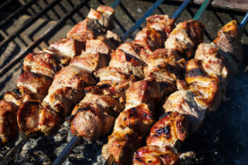 Pork kebabs on skewers on a close-up grill.