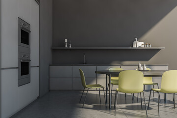 Grey kitchen interior with table and chairs, grey concrete floor