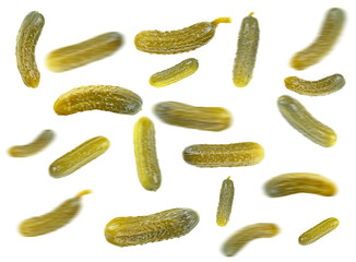 Falling cucumbers. Marinated pickled cucumbers isolated on a white background, selective focus.