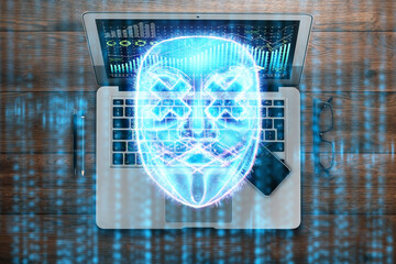 Hologram digital mask of a hacker on the background of a laptop, identity theft. Concept of internet crime, cyber attack, hacking of electronic wallets.