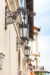 Sochi, Russia, April 12, 2021. Beautiful street lamps at the facade of building of the sea station, one of the tourist symbols of the city, Yachts in the port of Sochi Marina