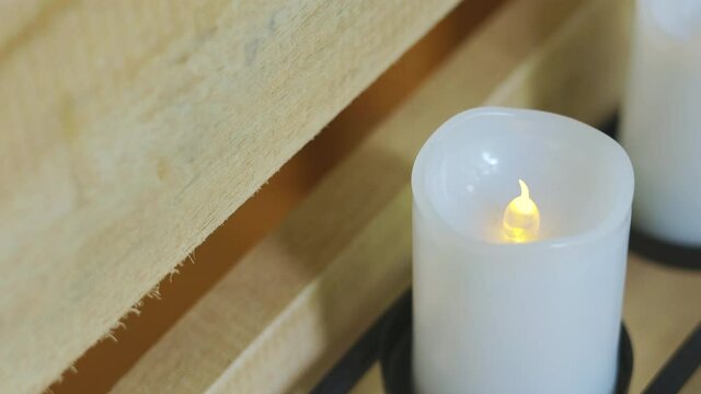 Close-up and selective focus 4K video of many plastic candle in a row with yellow light flickering as real candle for decoration in house shows clam and peace atmosphere for relaxing people.