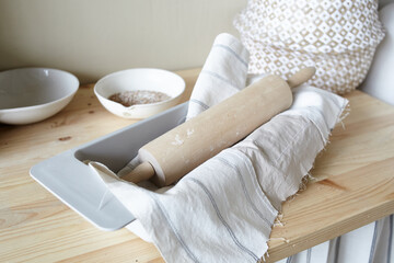 rolling pin in flour on a towel on the kitchen table