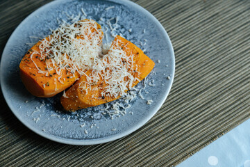 View of delicious sweet potatoes dish.Delicious sweet potatoes on plate high angle.Sweet potatoes with parmigiano
