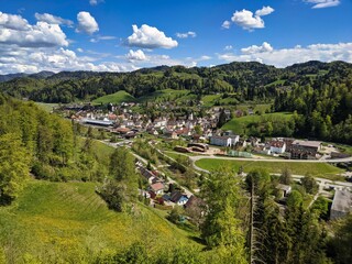 Fototapeta na wymiar View from the castle ruin altlandenberg to the small village of bauma in the toesstal zurich oberland. hills in spring