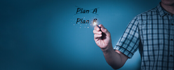 Business plan strategy changing.The man crossing over Plan A, writing Plan B.Concept is ....