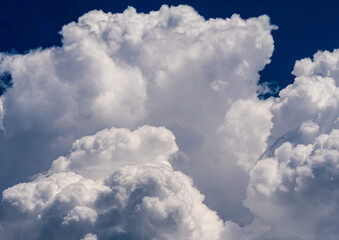 Naklejka na ściany i meble White fluffy big clouds against sky