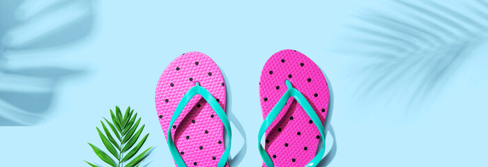 Flip flops with palm leaf shadow