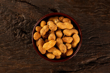 Bowl full of roasted peanuts.