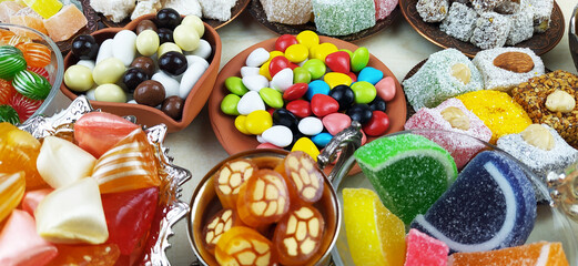 Fototapeta na wymiar All kinds of candies and marshmallows on various plates on white background.Traditional Turkish Delight, Turkish Sweet Sugar Ramadan (Ramadan) Food