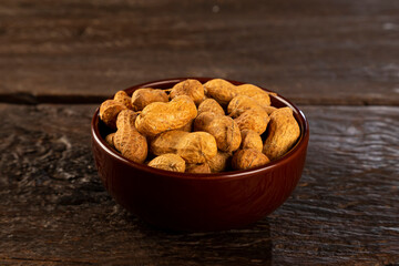 Bowl full of roasted peanuts.