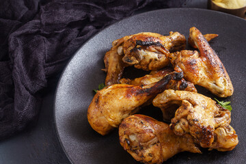 Roasted chicken wings and drumstick with copy space