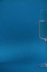 a glass of white wine isolated on blue background