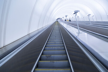 Fototapeta premium Escalator in the metro. Lifting ladder.The movement of passengers in the subway.