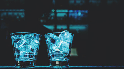 Ice cube in an empty glass on a bar counterin bar or pub