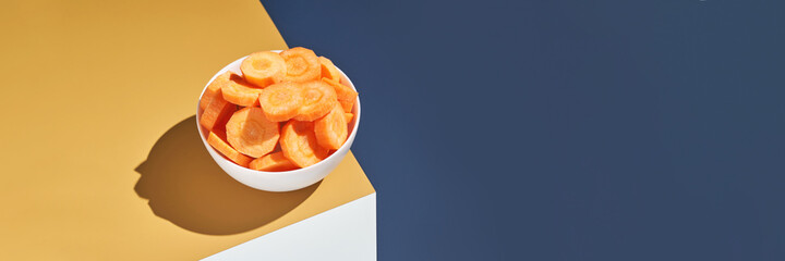 Crispy dried food. Organic tasty chips. Homemade snacks. Sliced carrot. Healthy vegetables. Orange pile Trend natural dish. Horizontal banner. Copyspace