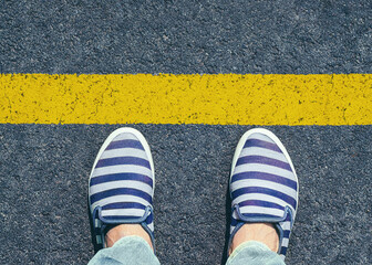 Women's feet in slippers shoes standing at the line.	