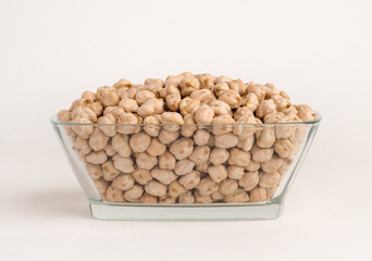 Chickpea in glass bowl on white background.