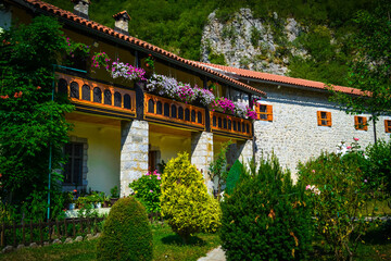 Monastery building with flowers in the background of mountains in Montenegro.