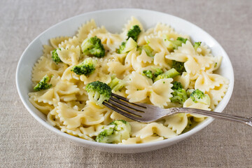 Pasta with broccoli on textile background