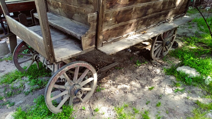 old stagecoach, with carriage wheels on a grassy ground