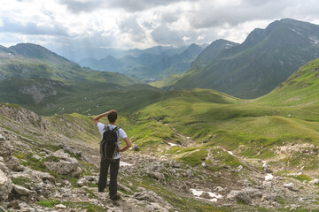 Young hiker look at the wonderful panorama in the swiss alps