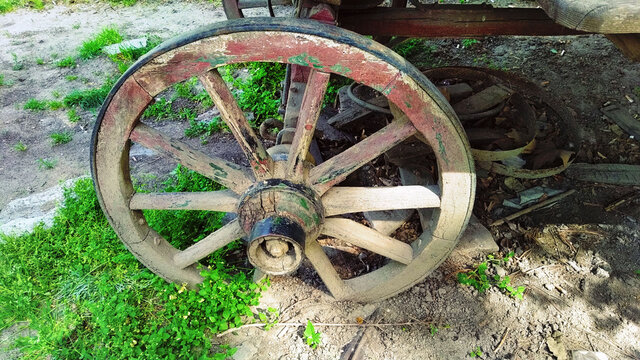 old wooden stagecoach wheel from a nomadic carriage, symbol of the gypsy community