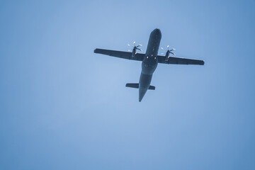 dark propeller plane flies very low
