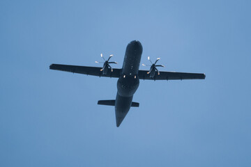 dark propeller plane flies very low