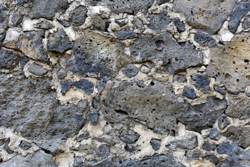 Texture of wall made of stone. Stone wall from colonial times.