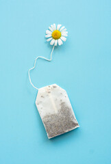 chamomile tea bag, herbal chamomile tea with fresh daisy flowers background, treatment and...