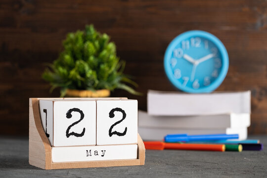 May 22nd. May 22 wooden cube calendar with blur objects on background.
