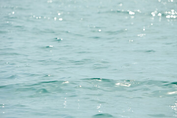 Texture of glitter water and soft waves. sparkling in water - background. sea water with sun glare...