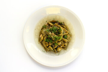 Broad bean and dill in the white plate with white background.