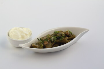 Broad bean and dill in the white plate with white background. With yoghurt