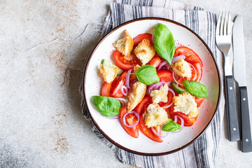 panzanella salad tomato, croutons, onion, olive oil, rusk on the table healthy food meal snack copy space food background rustic. top view keto or paleo diet veggie vegan or vegetarian food