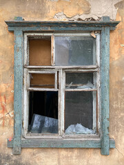 Broken window of an old house. The house is ready for demolition
