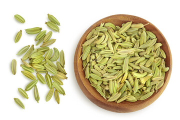 Dried fennel seeds in wooden bowl isolated on white background with clipping path. Top view. Flat lay