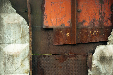 Texture of an abandoned reinforced concrete fence, with rust and peeling paint.