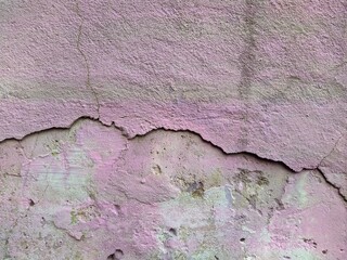 old pink concrete wall with cracked pattern in the middle